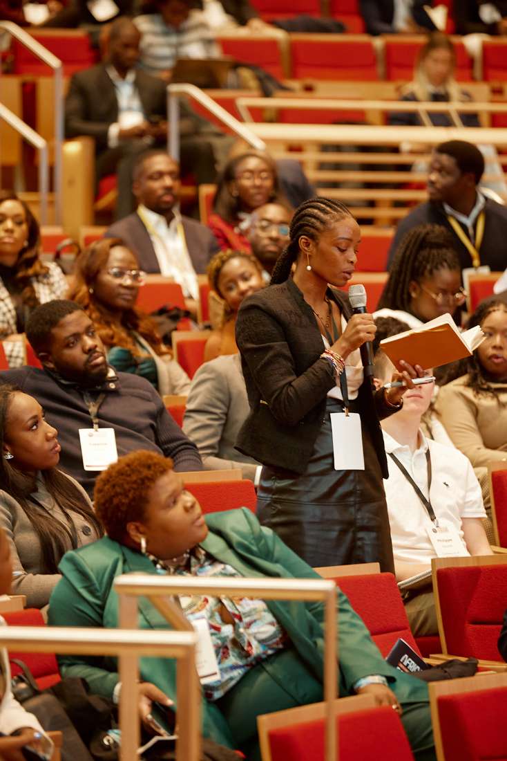 Attendee asking a question from the auditorium floor